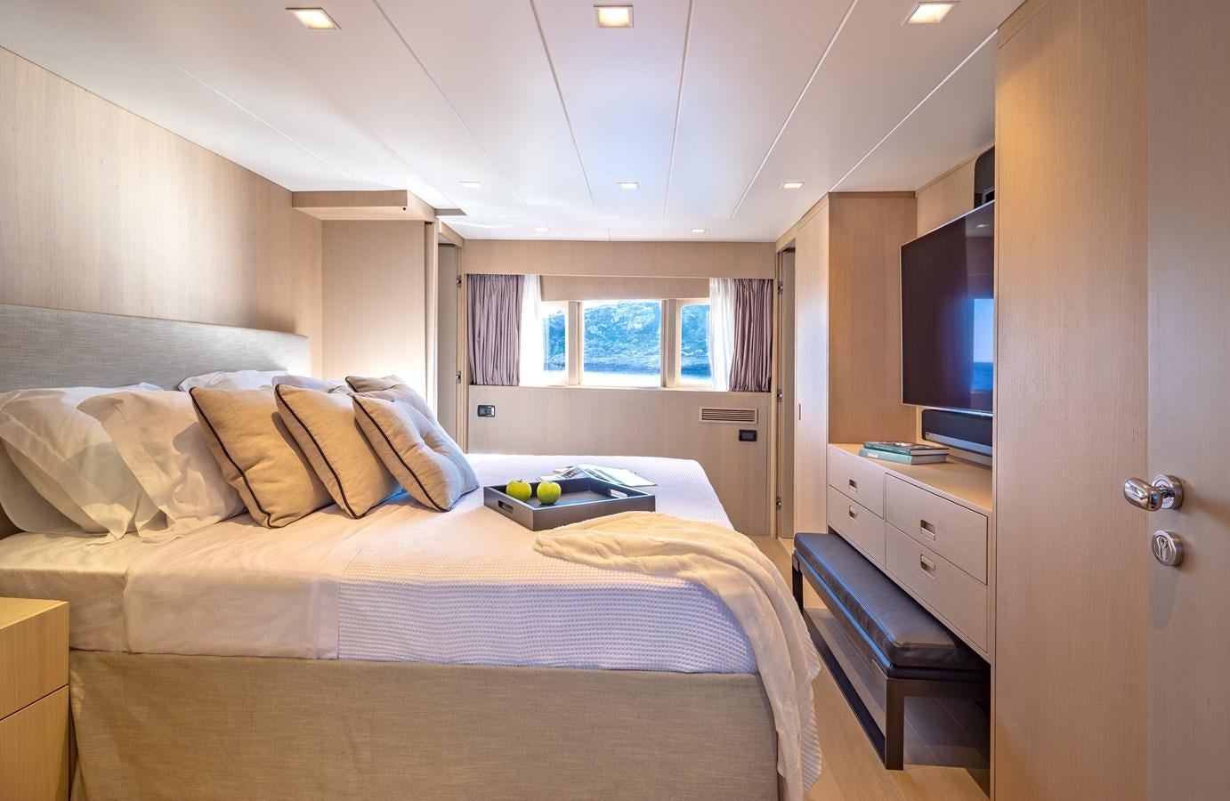 a bedroom with a bed and a tv on the wall aboard SUMMER FUN Yacht for Sale