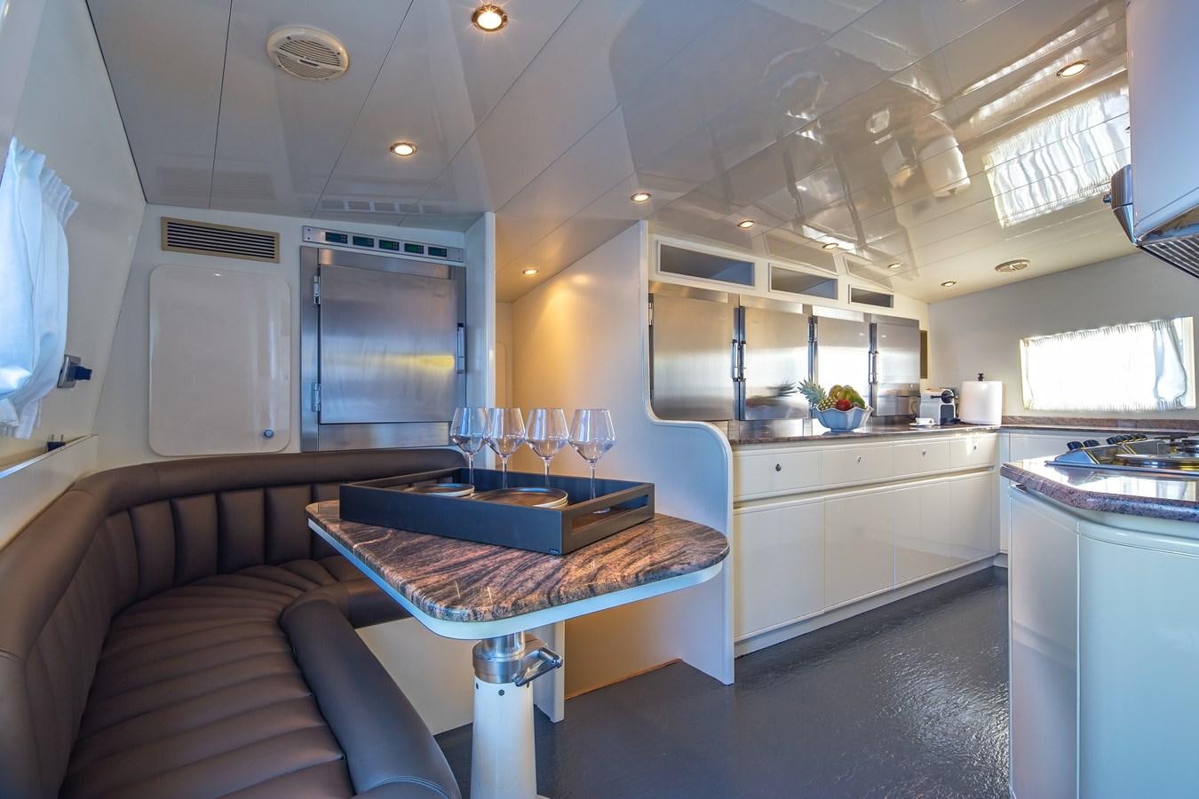 a kitchen with a table and a couch aboard SUMMER FUN Yacht for Sale