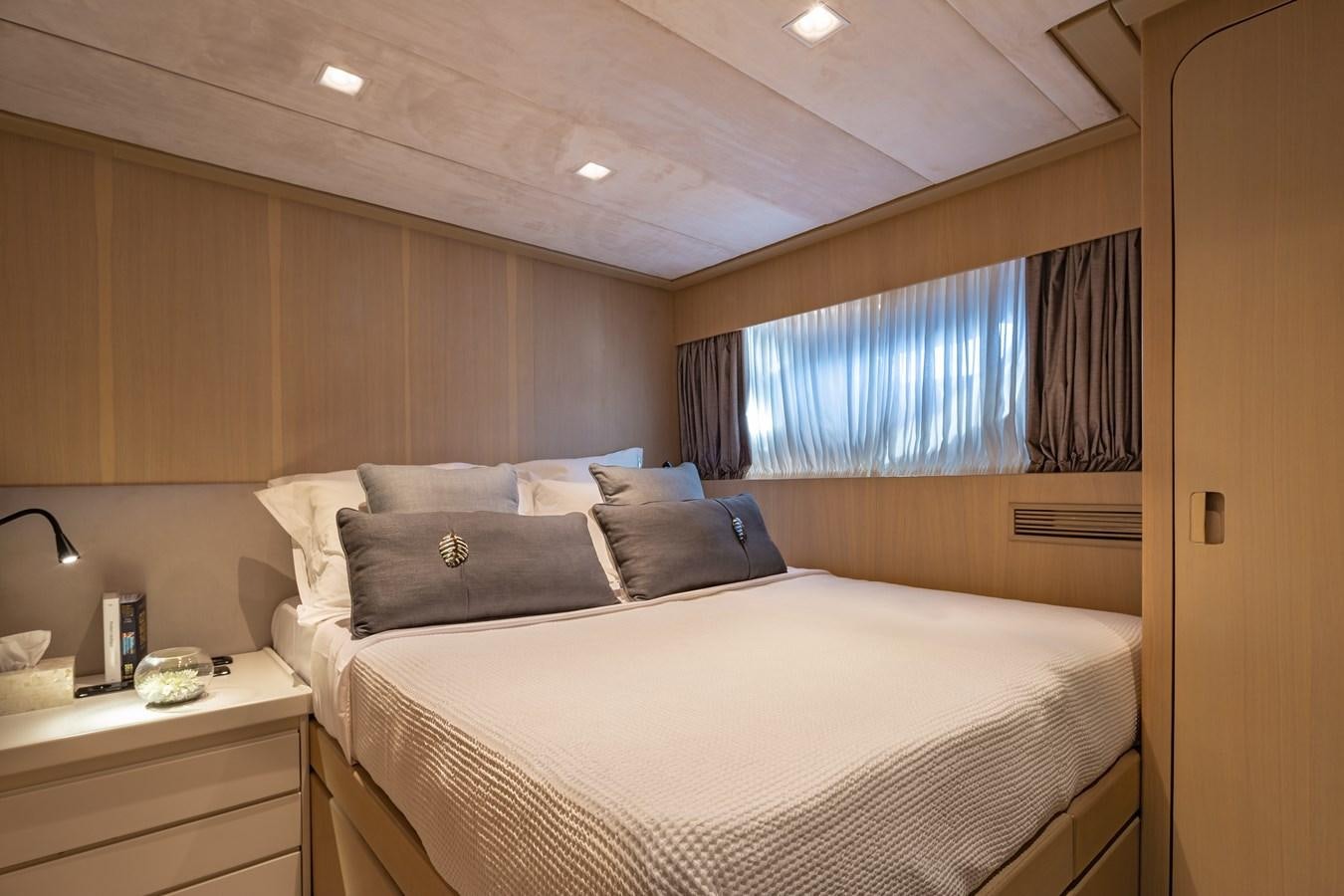 a bed with a white bed spread aboard SUMMER FUN Yacht for Sale