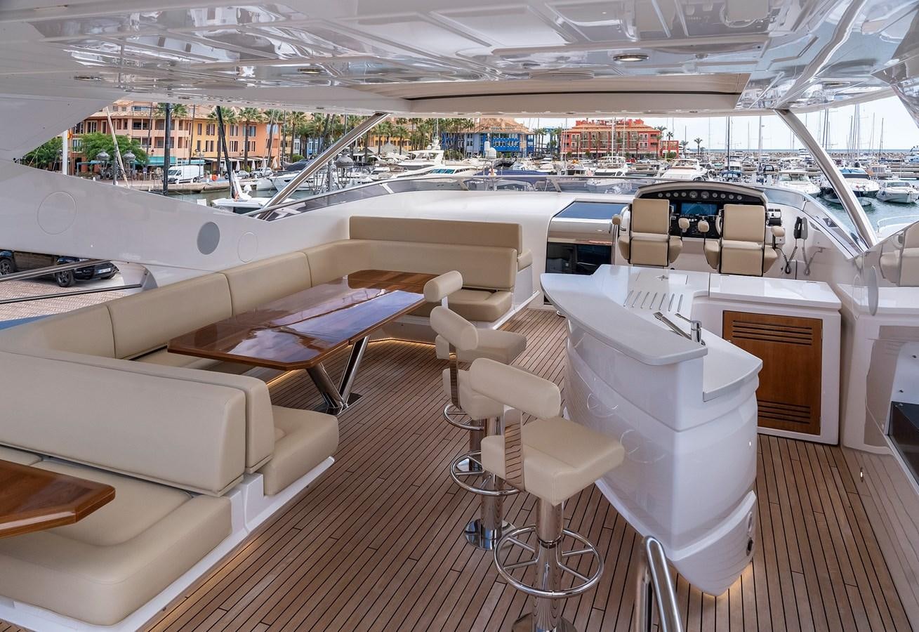 a room with a table and chairs aboard LADY M Yacht for Sale