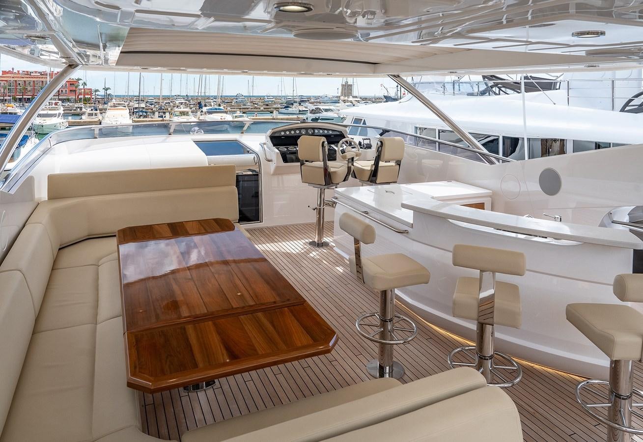 a room with a table and chairs aboard LADY M Yacht for Sale
