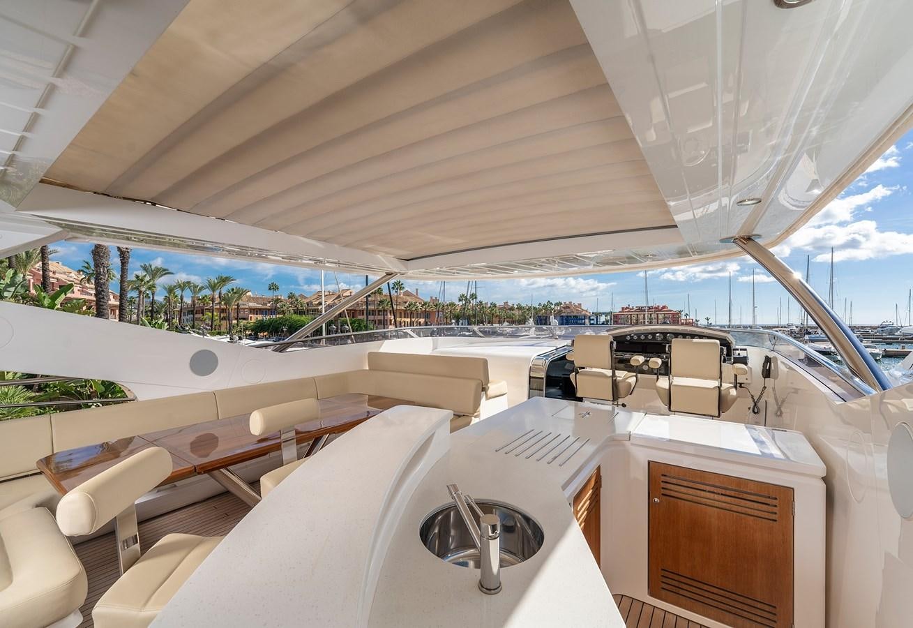 a large white tent with a view of a beach and water aboard LADY M Yacht for Sale