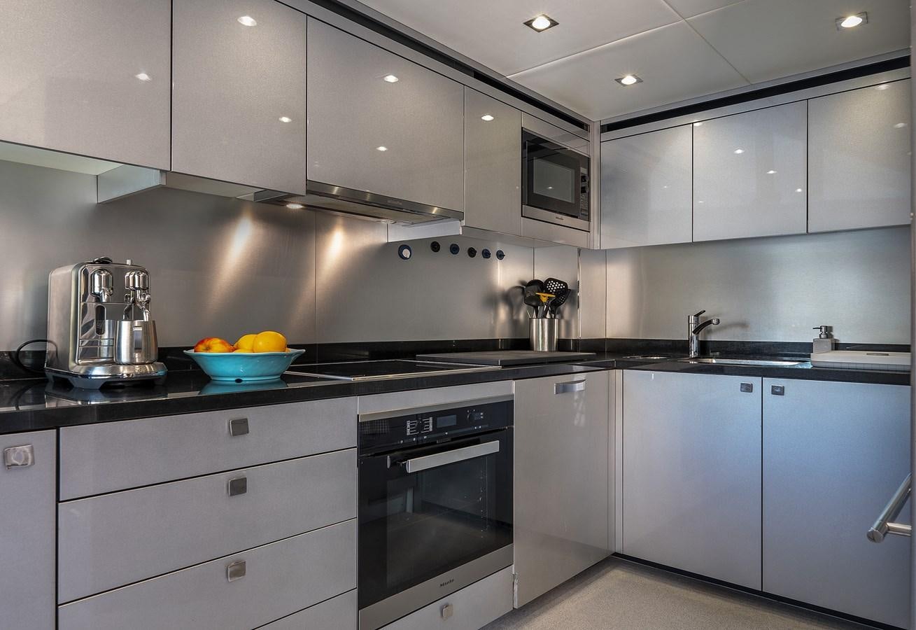 a kitchen with white cabinets aboard LADY M Yacht for Sale