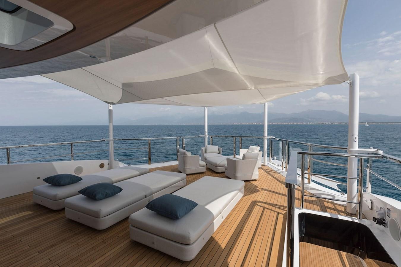 a large white lounge chair on a deck overlooking the ocean aboard MAVERICK Yacht for Sale