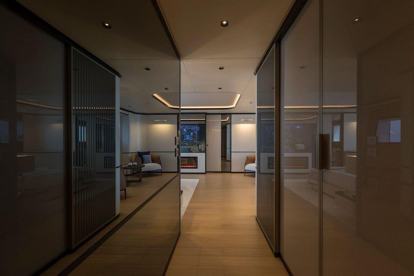 a room with a glass wall and a wood floor and a door with a glass door aboard MAVERICK Yacht for Sale