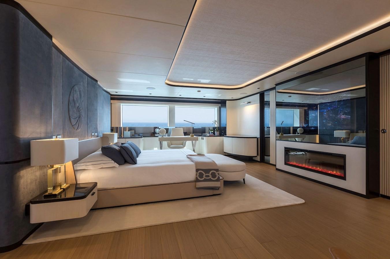 a modern bedroom with a large window aboard MAVERICK Yacht for Sale