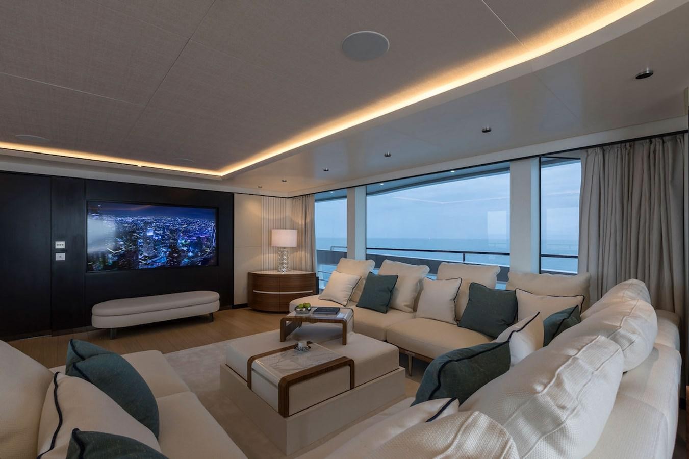 a living room with a large flat screen television and a large window aboard MAVERICK Yacht for Sale