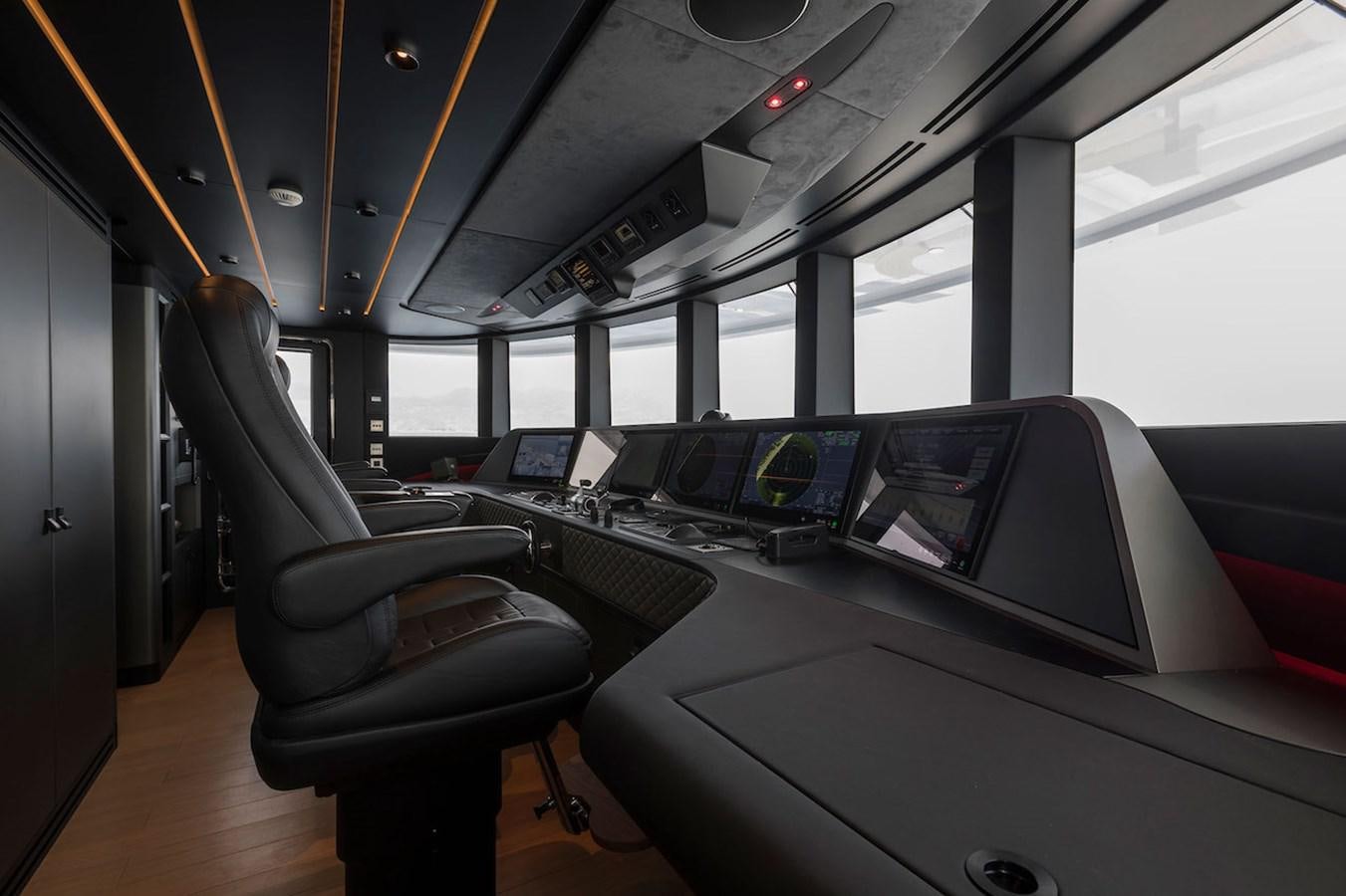 inside of a vehicle with seats and a desk with a computer on it aboard MAVERICK Yacht for Sale
