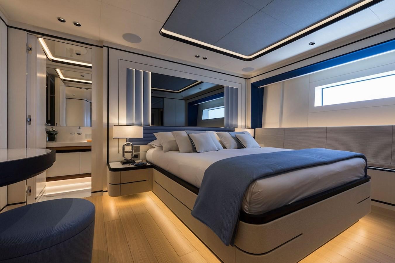 a bedroom with a bed and a desk aboard MAVERICK Yacht for Sale