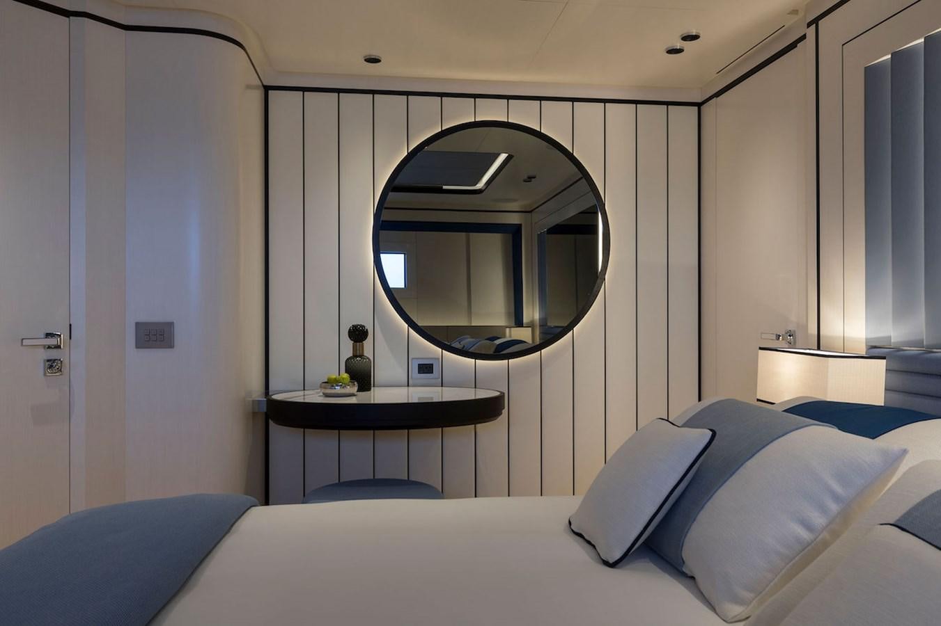 a bed with a round mirror above it aboard MAVERICK Yacht for Sale