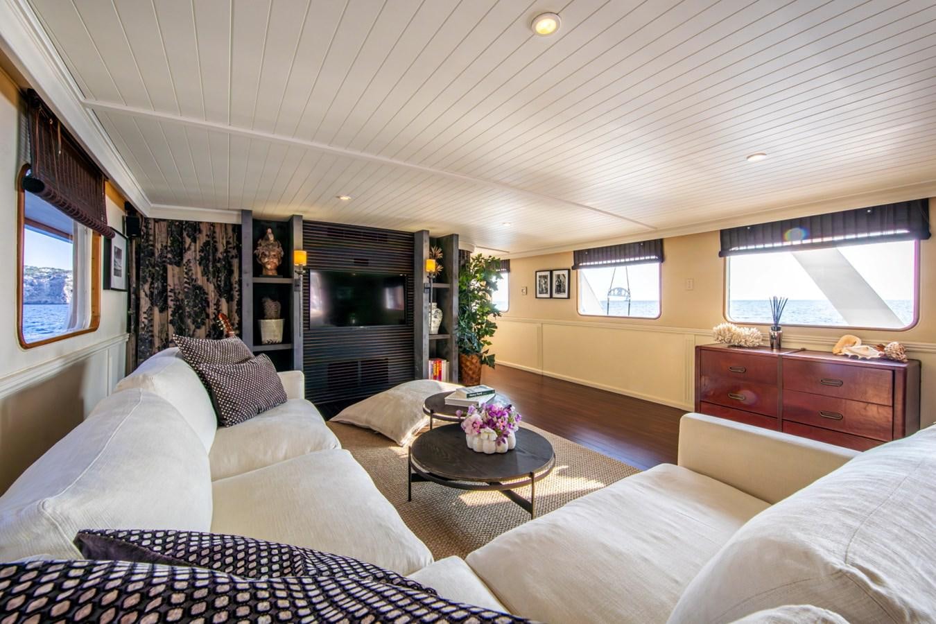 a living room with a couch and a coffee table aboard SANTA MARIA Yacht for Sale