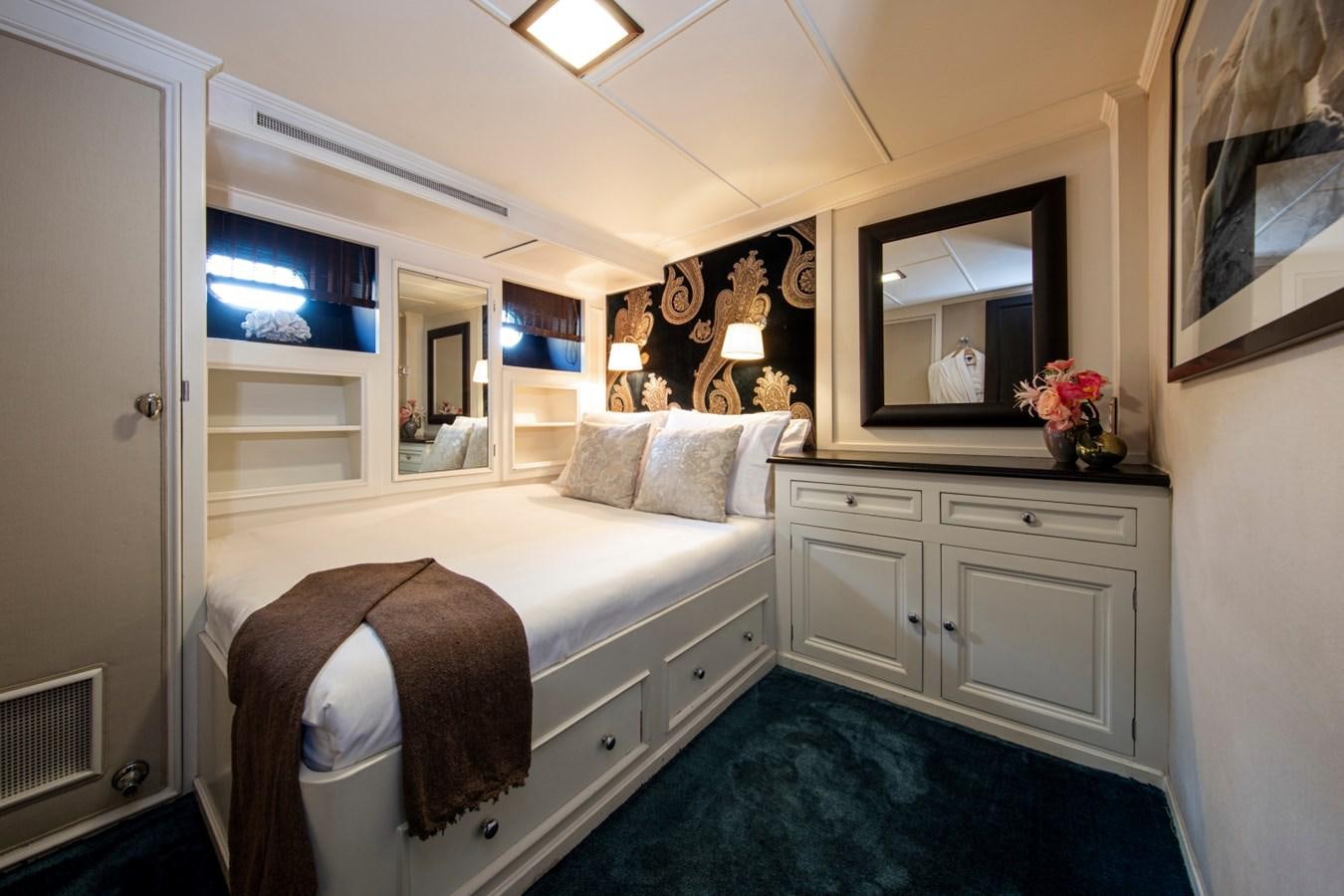 a bedroom with a bed and a mirror aboard SANTA MARIA Yacht for Sale