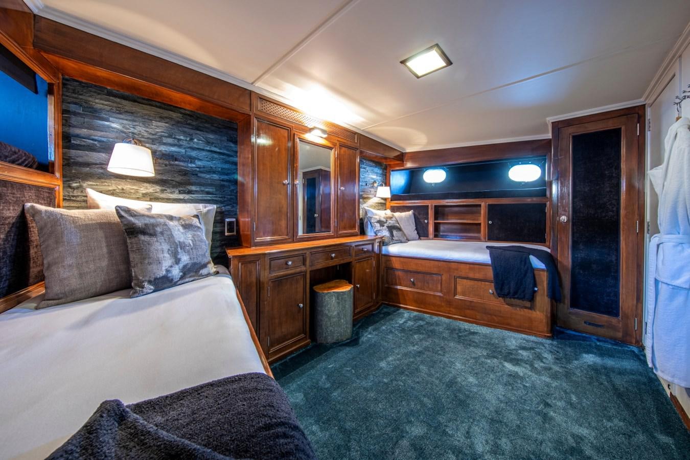 a bedroom with a bed and a desk aboard SANTA MARIA Yacht for Sale