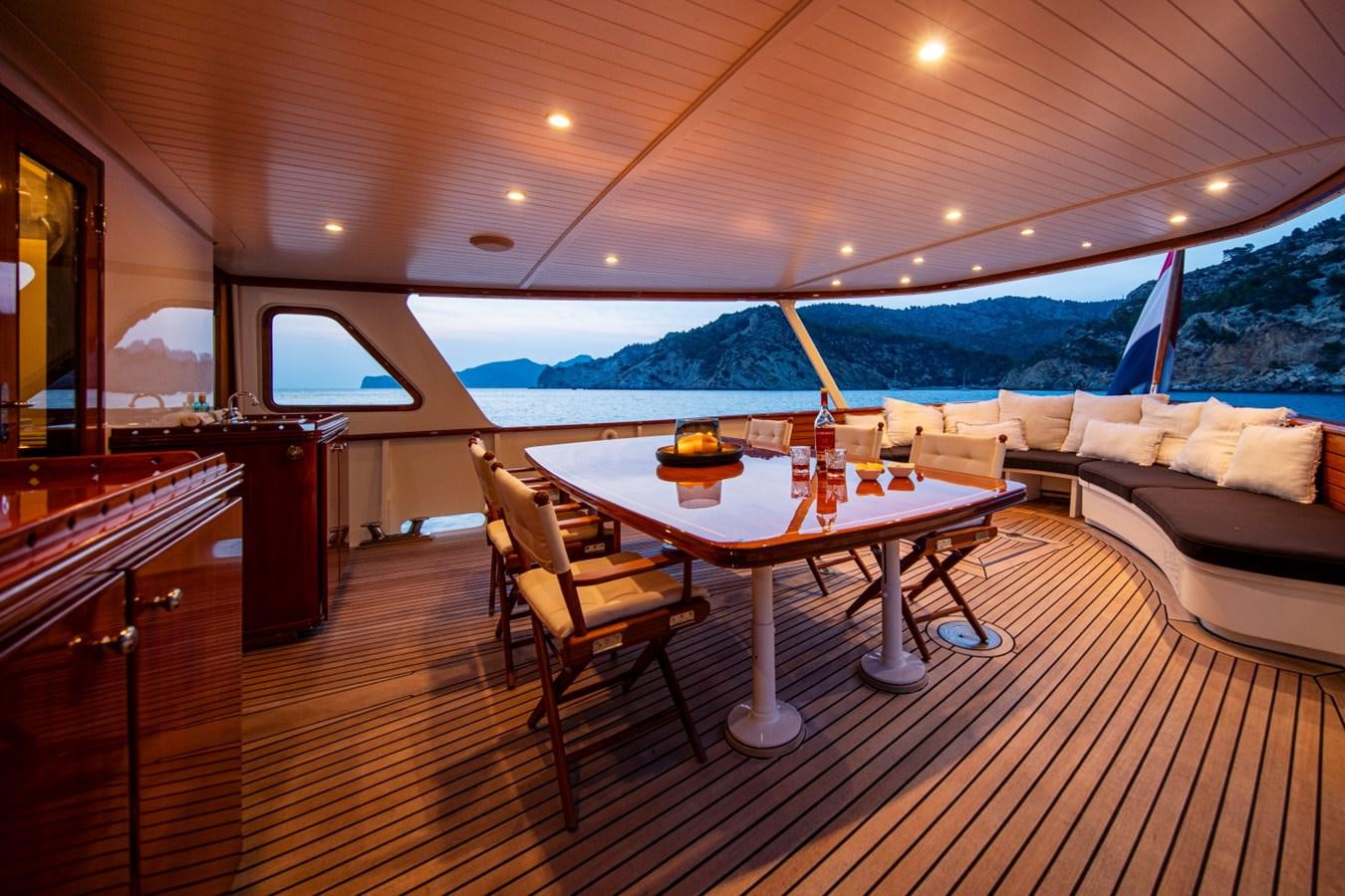 a room with a table and chairs aboard SANTA MARIA Yacht for Sale