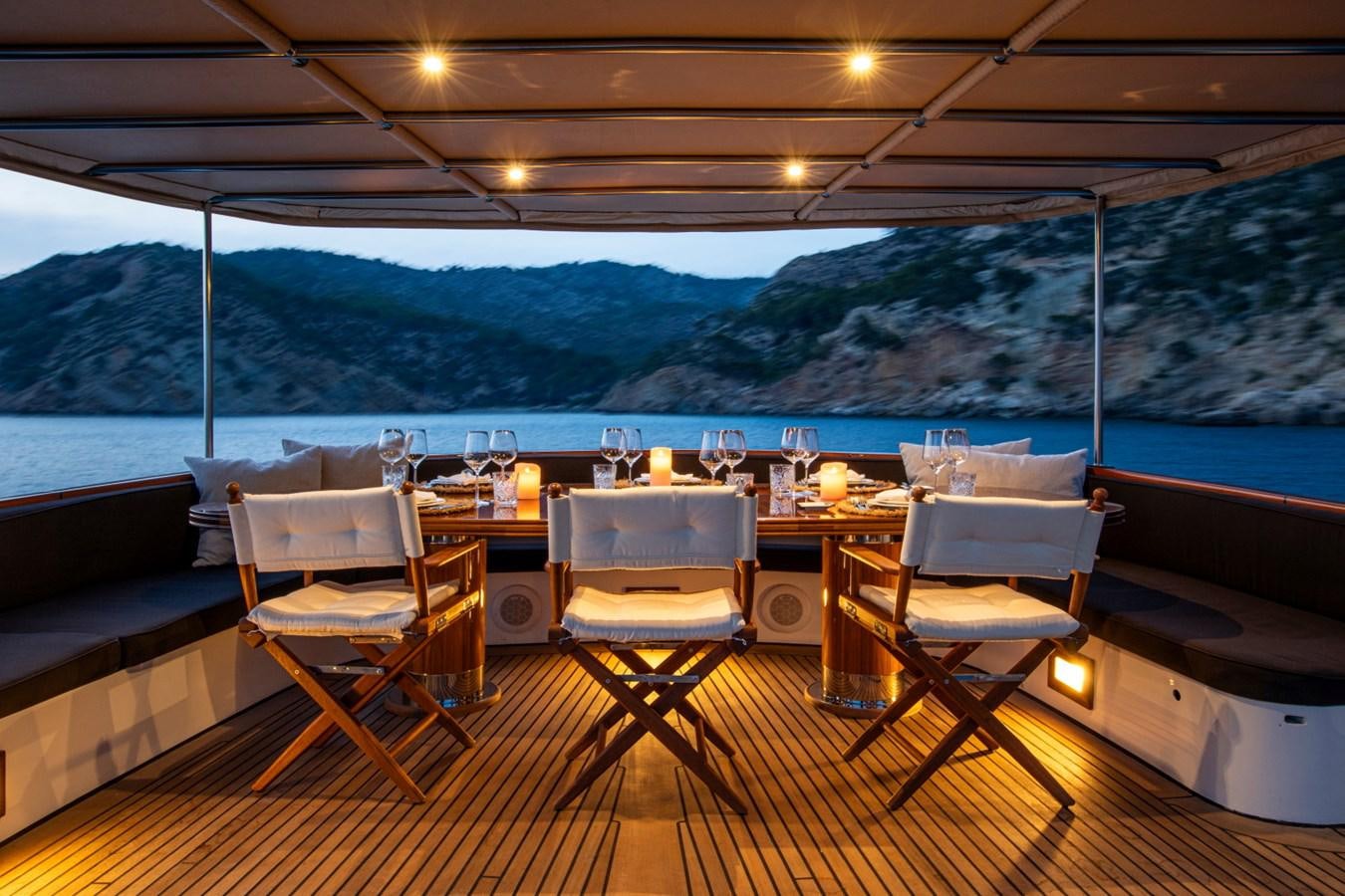 a table with chairs on it aboard SANTA MARIA Yacht for Sale