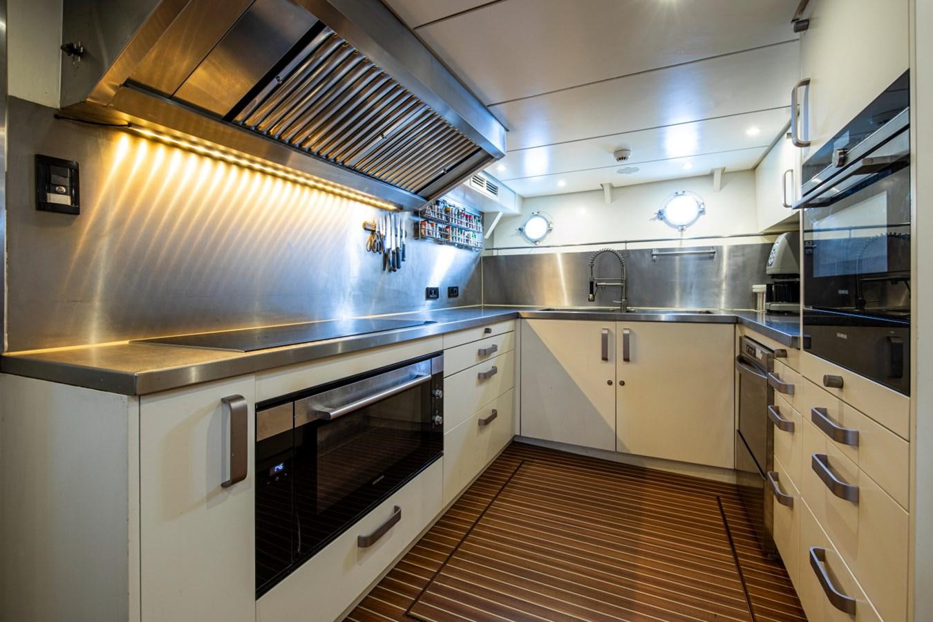 a kitchen with white cabinets aboard SANTA MARIA Yacht for Sale