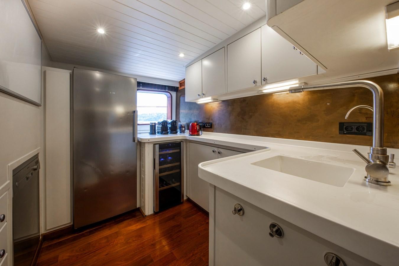 a kitchen with a stainless steel refrigerator aboard SANTA MARIA Yacht for Sale