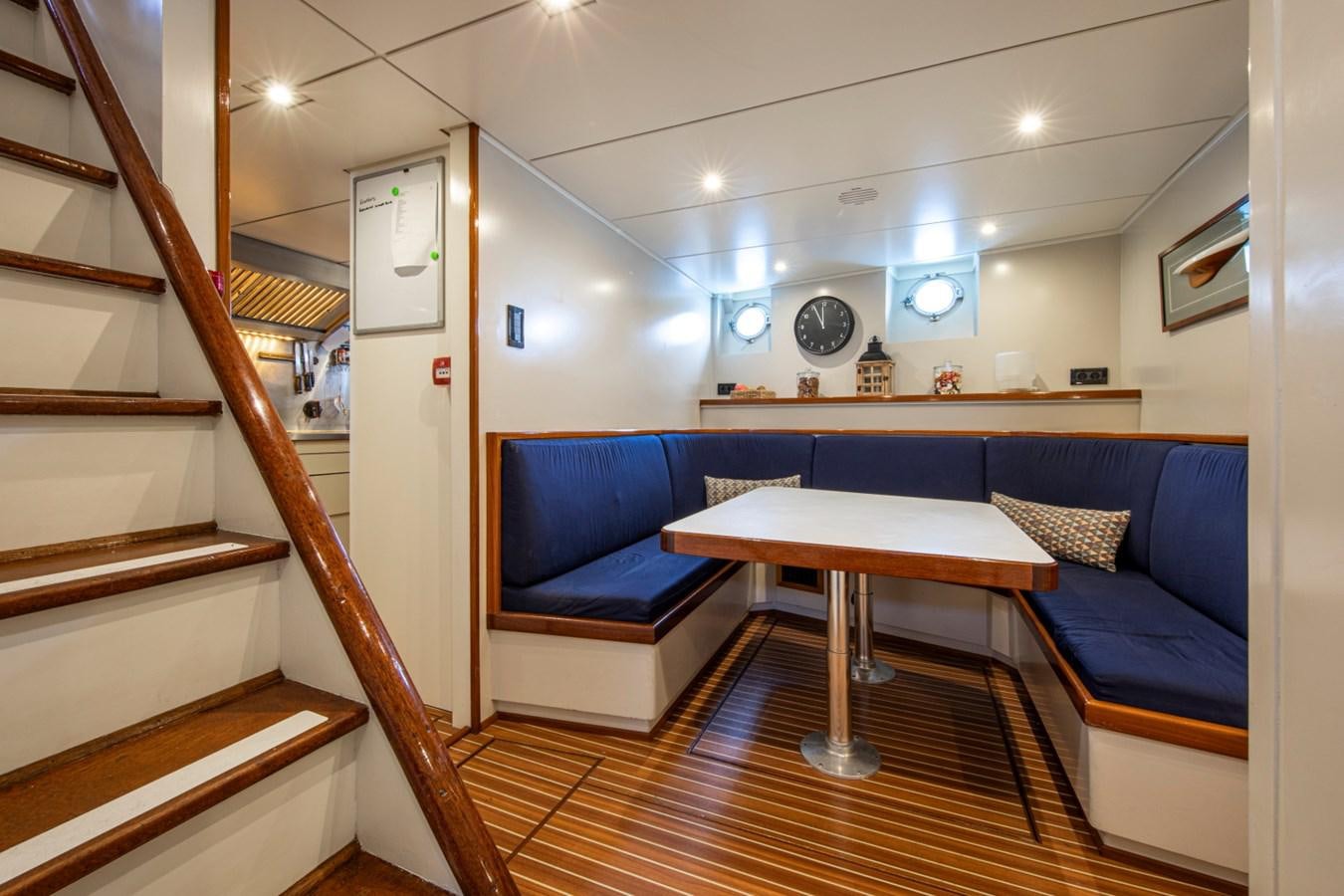 a room with a table and couch aboard SANTA MARIA Yacht for Sale