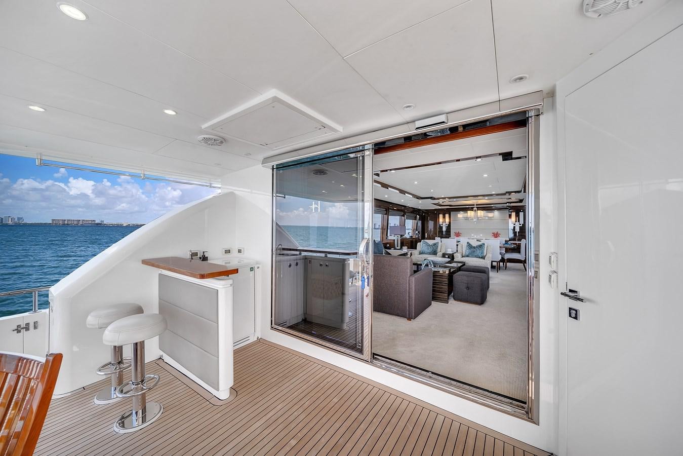 a room with a large glass door and a view of the ocean aboard 101' HARGRAVE Yacht for Sale