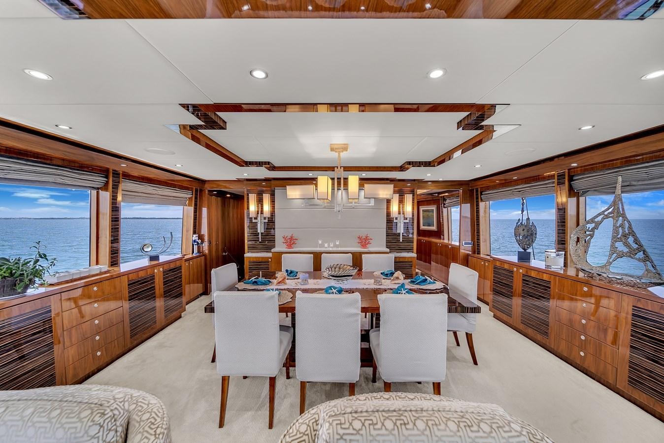 a large dining room with a large open kitchen and dining area aboard 101' HARGRAVE Yacht for Sale