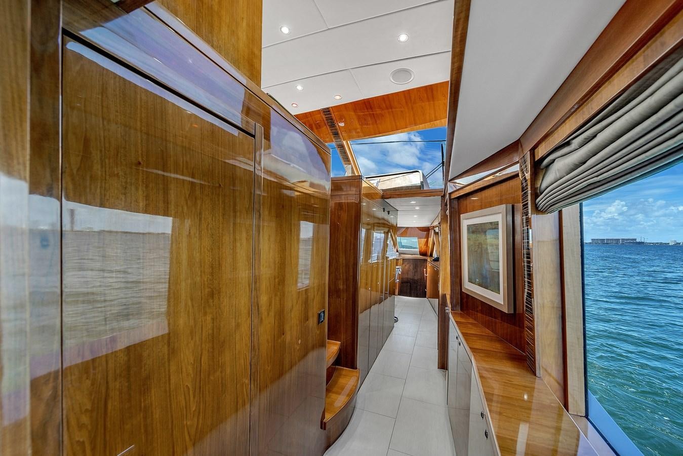 a long hallway with glass doors aboard 101' HARGRAVE Yacht for Sale