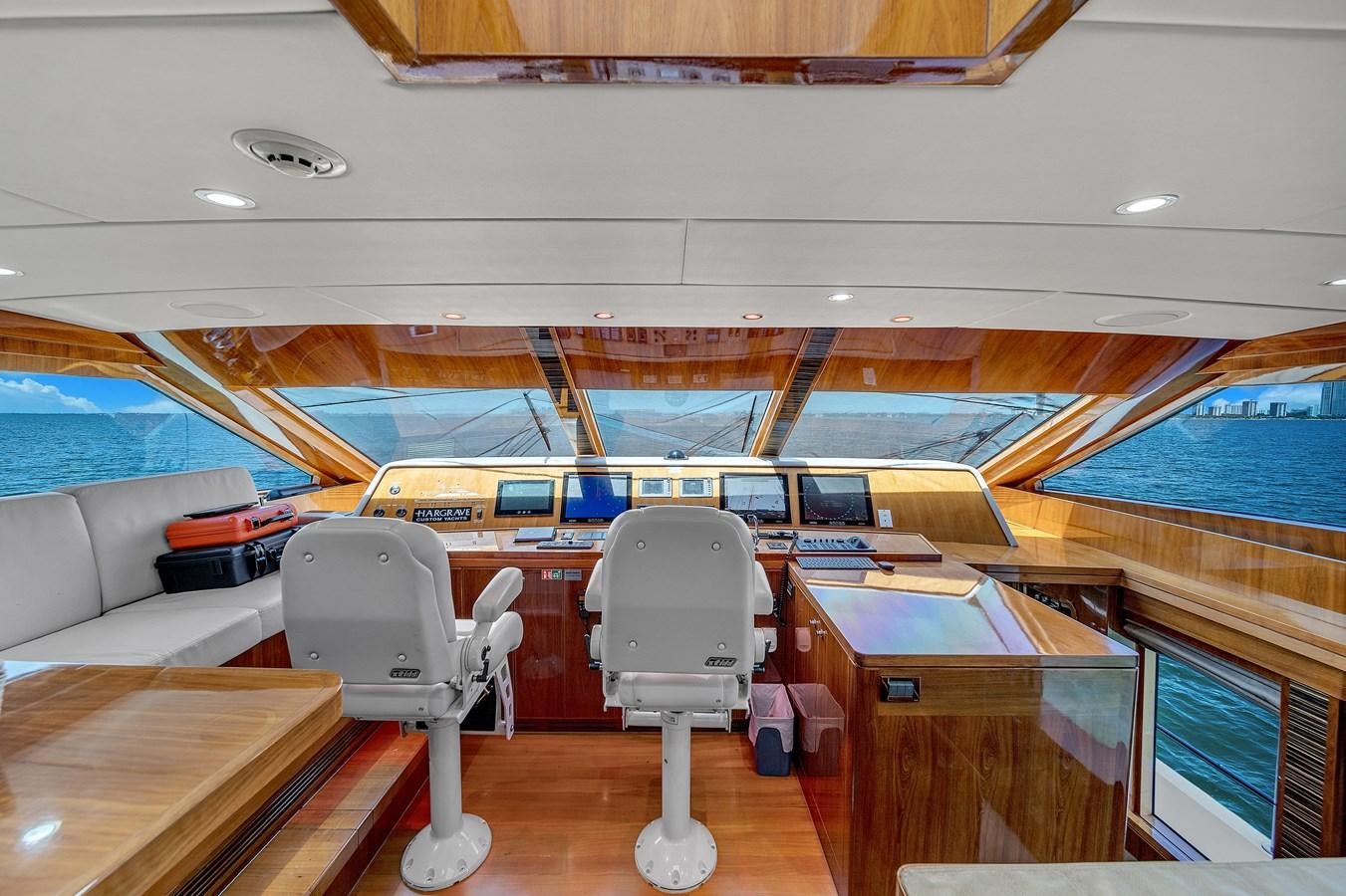 a room with a large window and chairs and a desk with a chair aboard 101' HARGRAVE Yacht for Sale