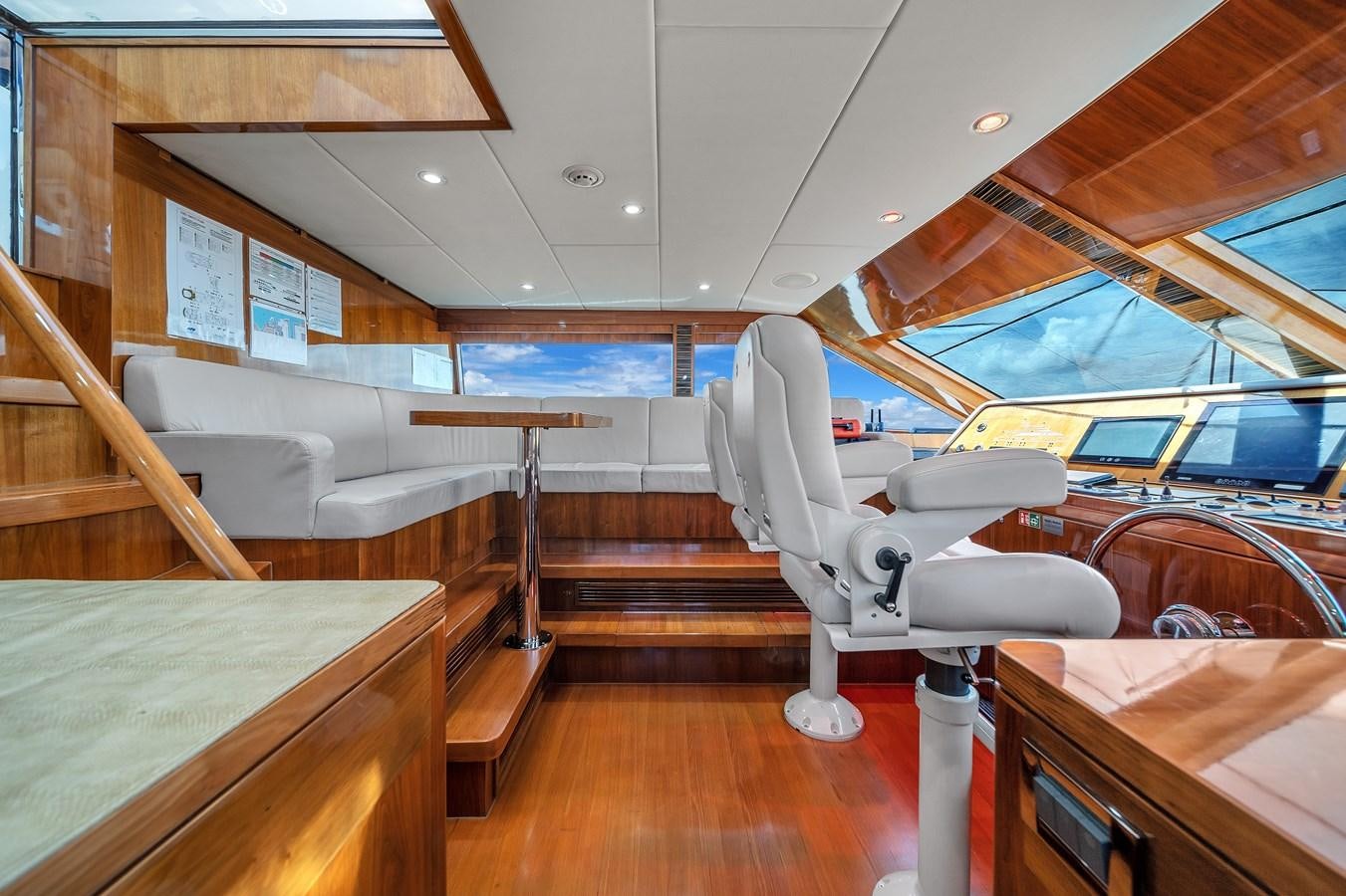 a room with a chair and a table and a bench aboard 101' HARGRAVE Yacht for Sale