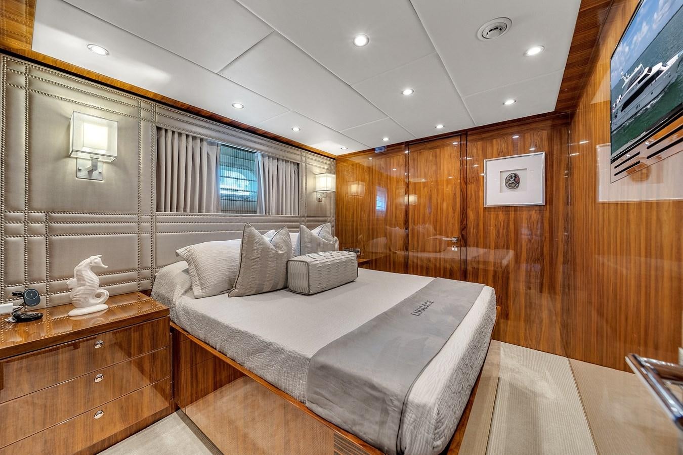 a room with a bed and a tv aboard 101' HARGRAVE Yacht for Sale