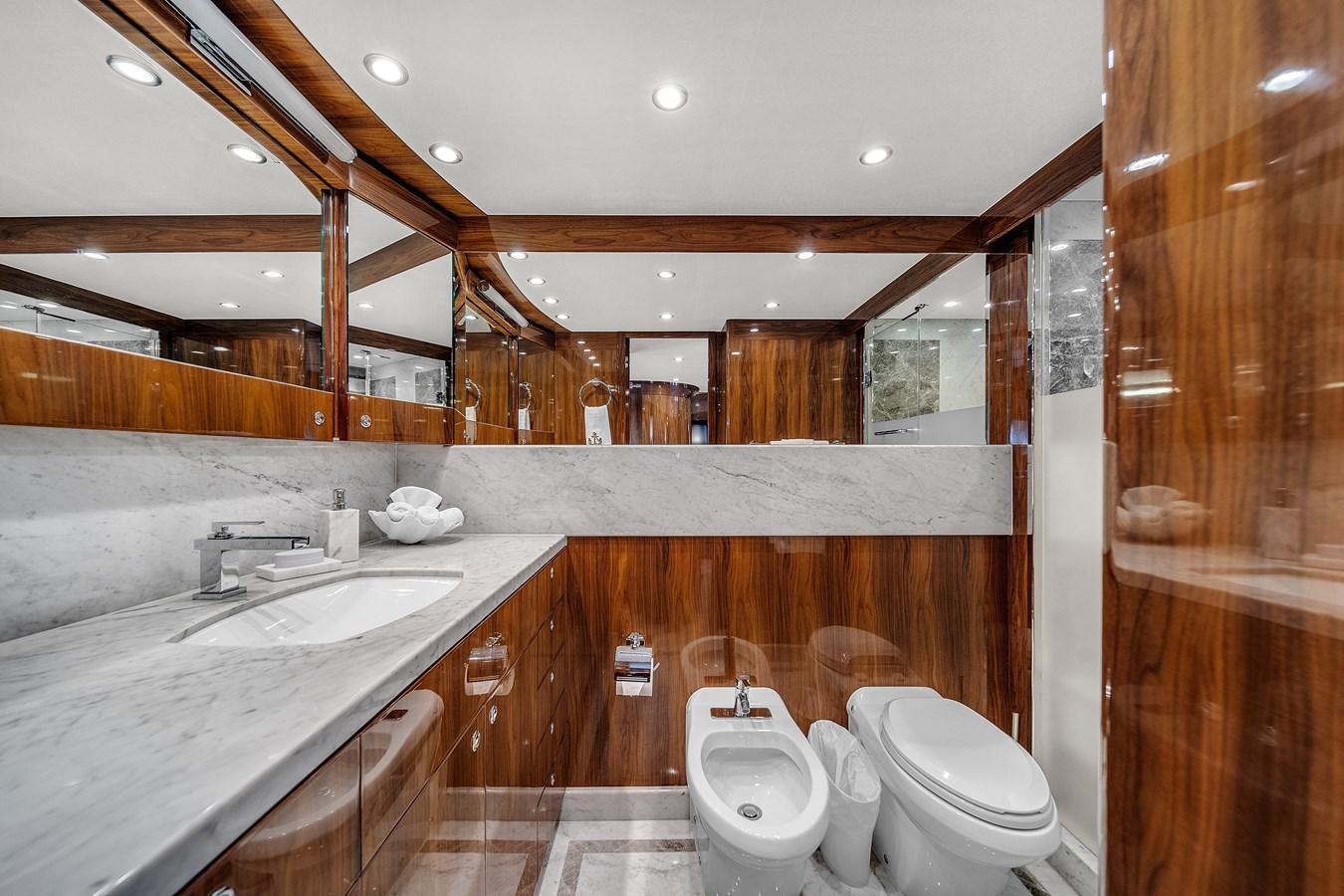a bathroom with a sink toilet and a mirror aboard 101' HARGRAVE Yacht for Sale