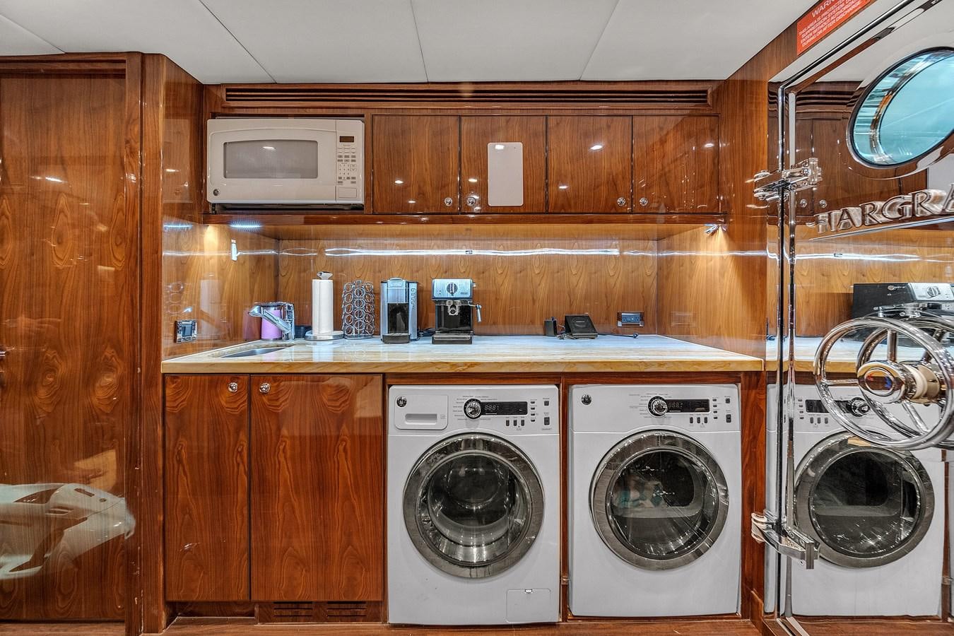 a room with a shelf and washer and dryer aboard 101' HARGRAVE Yacht for Sale