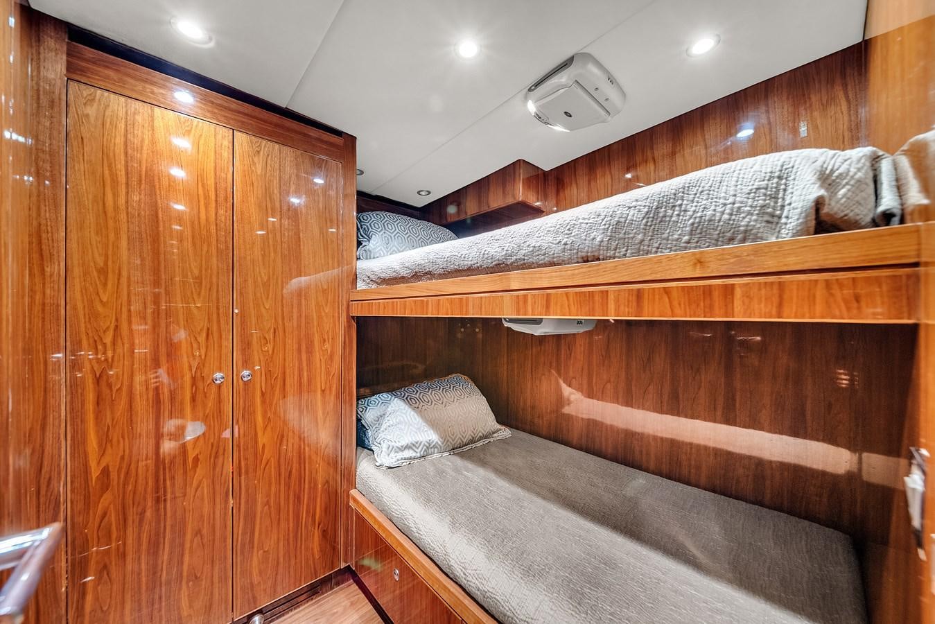 a bed with wooden furniture aboard 101' HARGRAVE Yacht for Sale