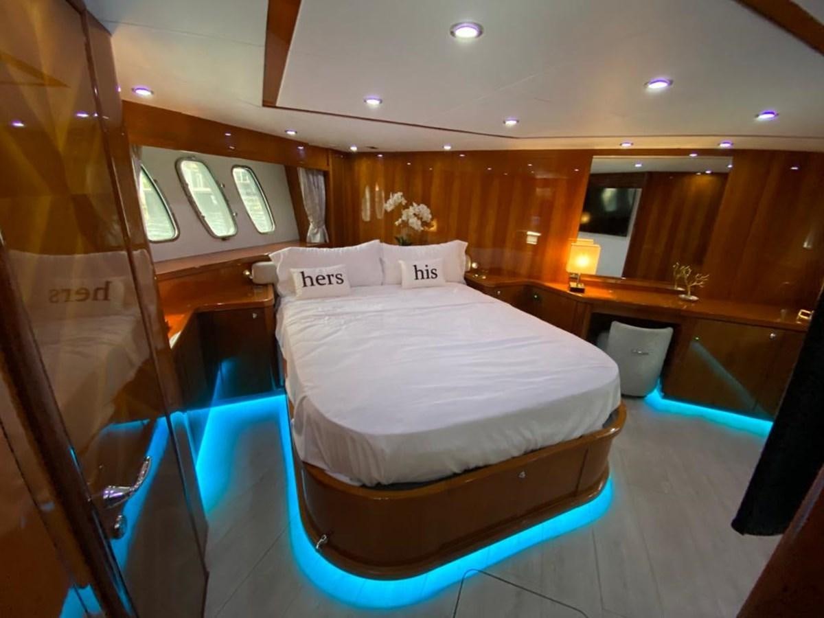 a room with a bed and a window aboard SOUL MATES Yacht for Sale