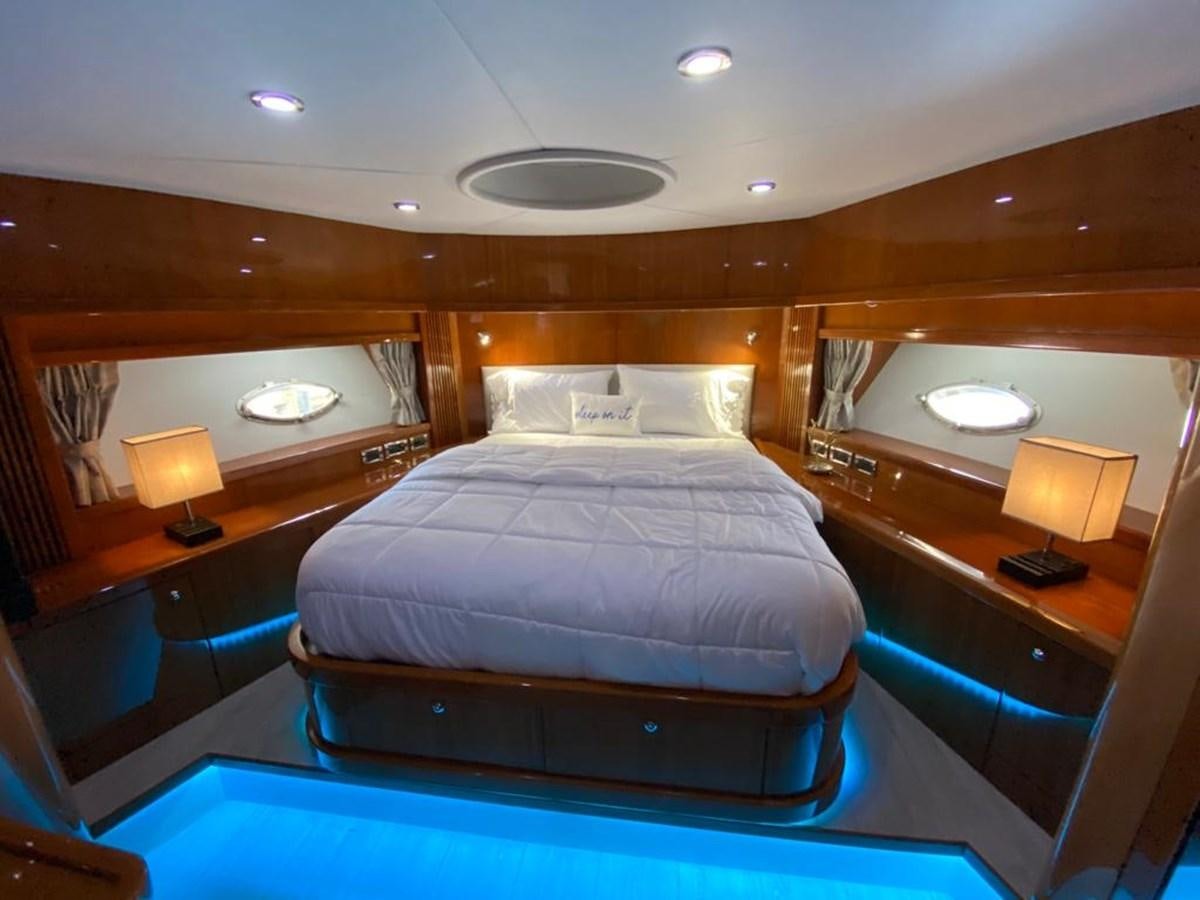 a bedroom with a bed and a desk aboard SOUL MATES Yacht for Sale