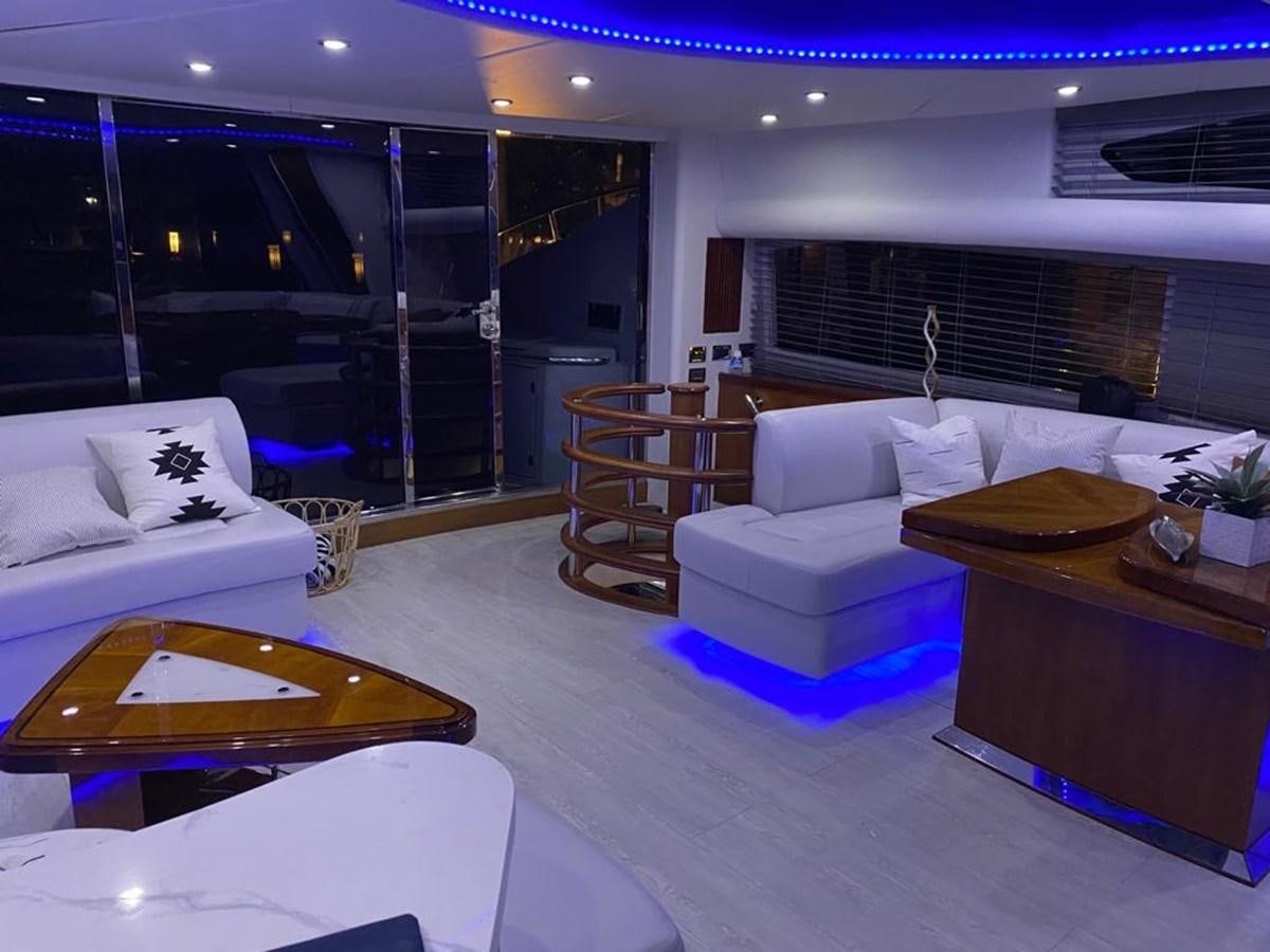 a living room with a table and couches aboard SOUL MATES Yacht for Sale