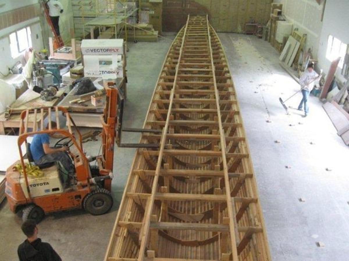 a person on a cart full of wood aboard 2023 PDIGREE CAT BLOOMFIELD Yacht for Sale