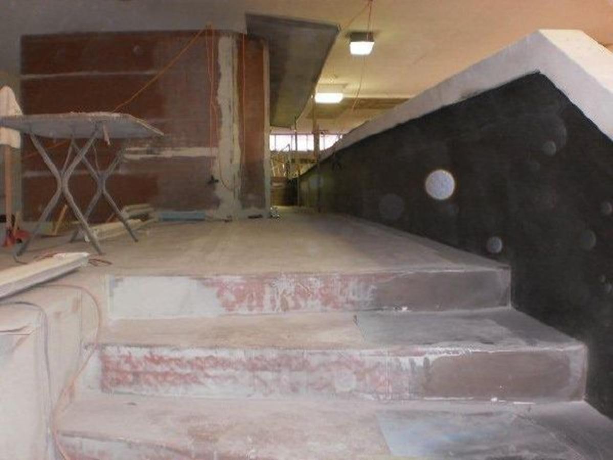 a large room with a fireplace aboard 2023 PDIGREE CAT BLOOMFIELD Yacht for Sale