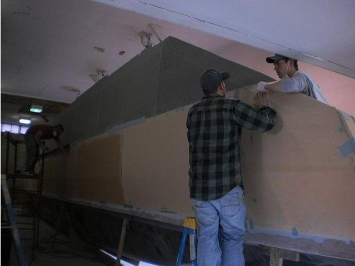 a man painting a large room aboard 2023 PDIGREE CAT BLOOMFIELD Yacht for Sale