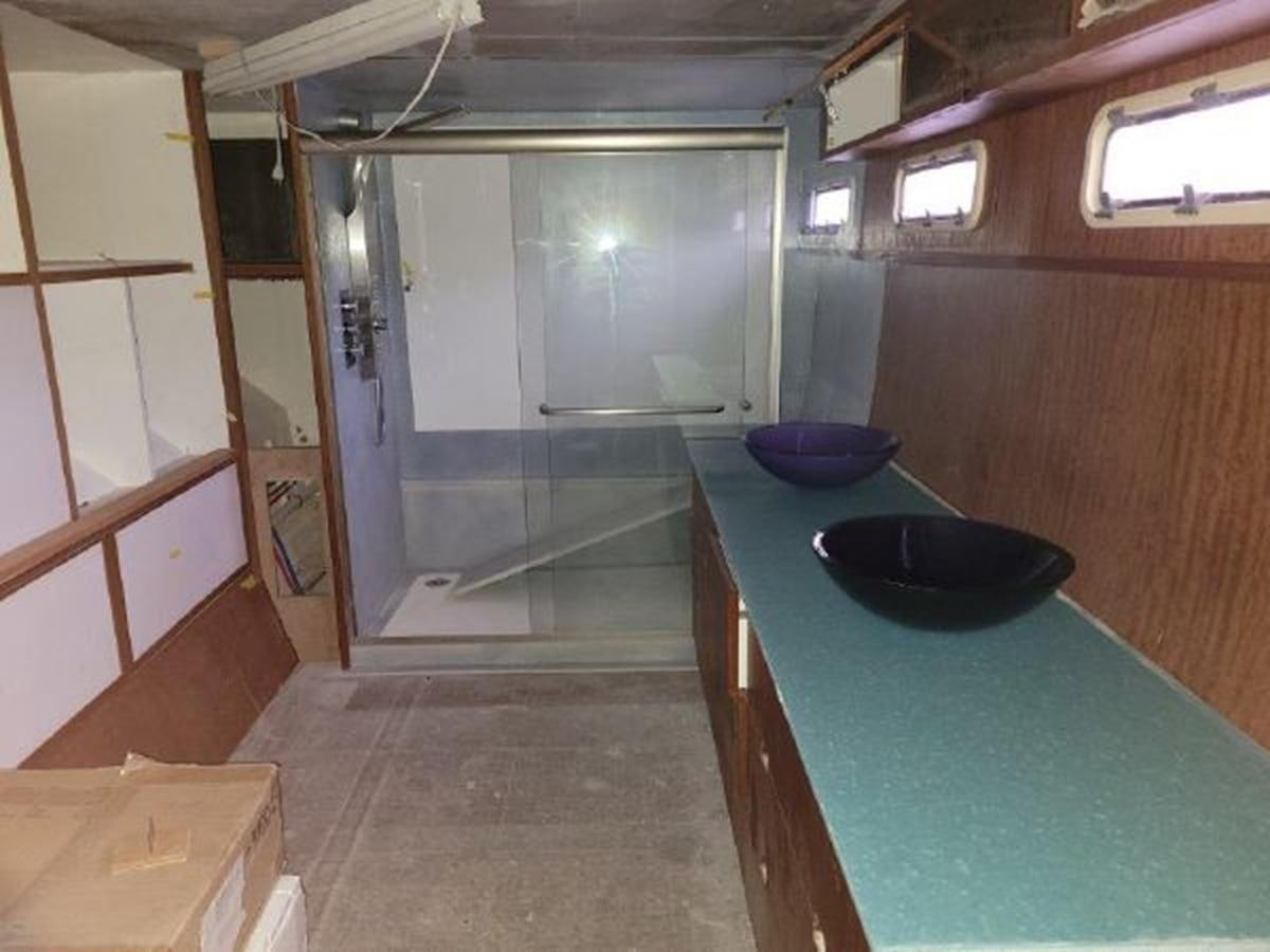 a kitchen with a sink and a blue counter aboard 2023 PDIGREE CAT BLOOMFIELD Yacht for Sale