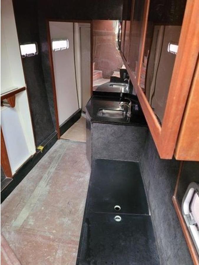a kitchen with black counter tops aboard 2023 PDIGREE CAT BLOOMFIELD Yacht for Sale