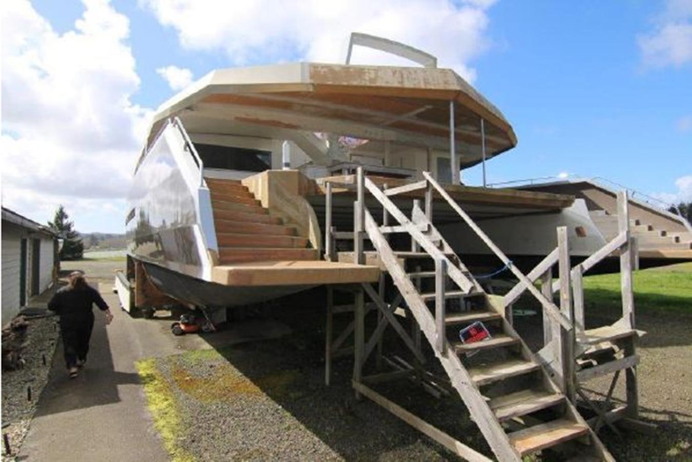 a person walking up a flight of stairs to a building aboard 2023 PDIGREE CAT BLOOMFIELD Yacht for Sale