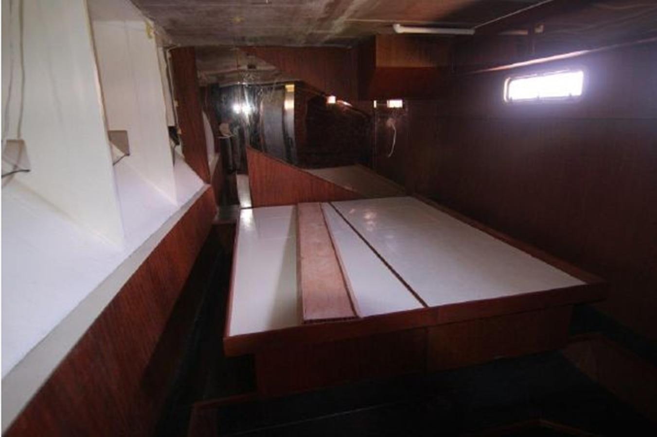 a large wooden table aboard 2023 PDIGREE CAT BLOOMFIELD Yacht for Sale