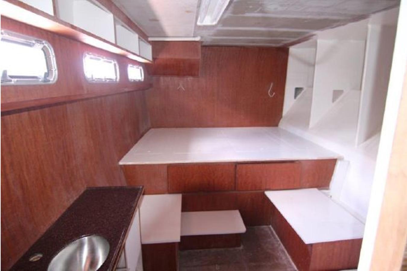 a room with a table and chairs aboard 2023 PDIGREE CAT BLOOMFIELD Yacht for Sale