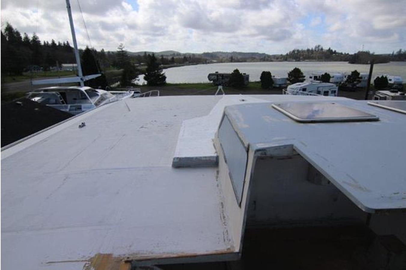 a parking lot with cars aboard 2023 PDIGREE CAT BLOOMFIELD Yacht for Sale