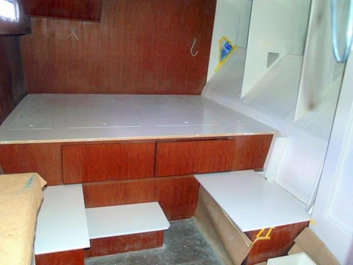 a room with a counter and cabinets aboard 2023 PDIGREE CAT BLOOMFIELD Yacht for Sale