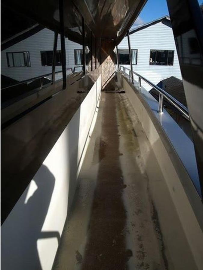 a walkway with a wood deck aboard 2023 PDIGREE CAT BLOOMFIELD Yacht for Sale