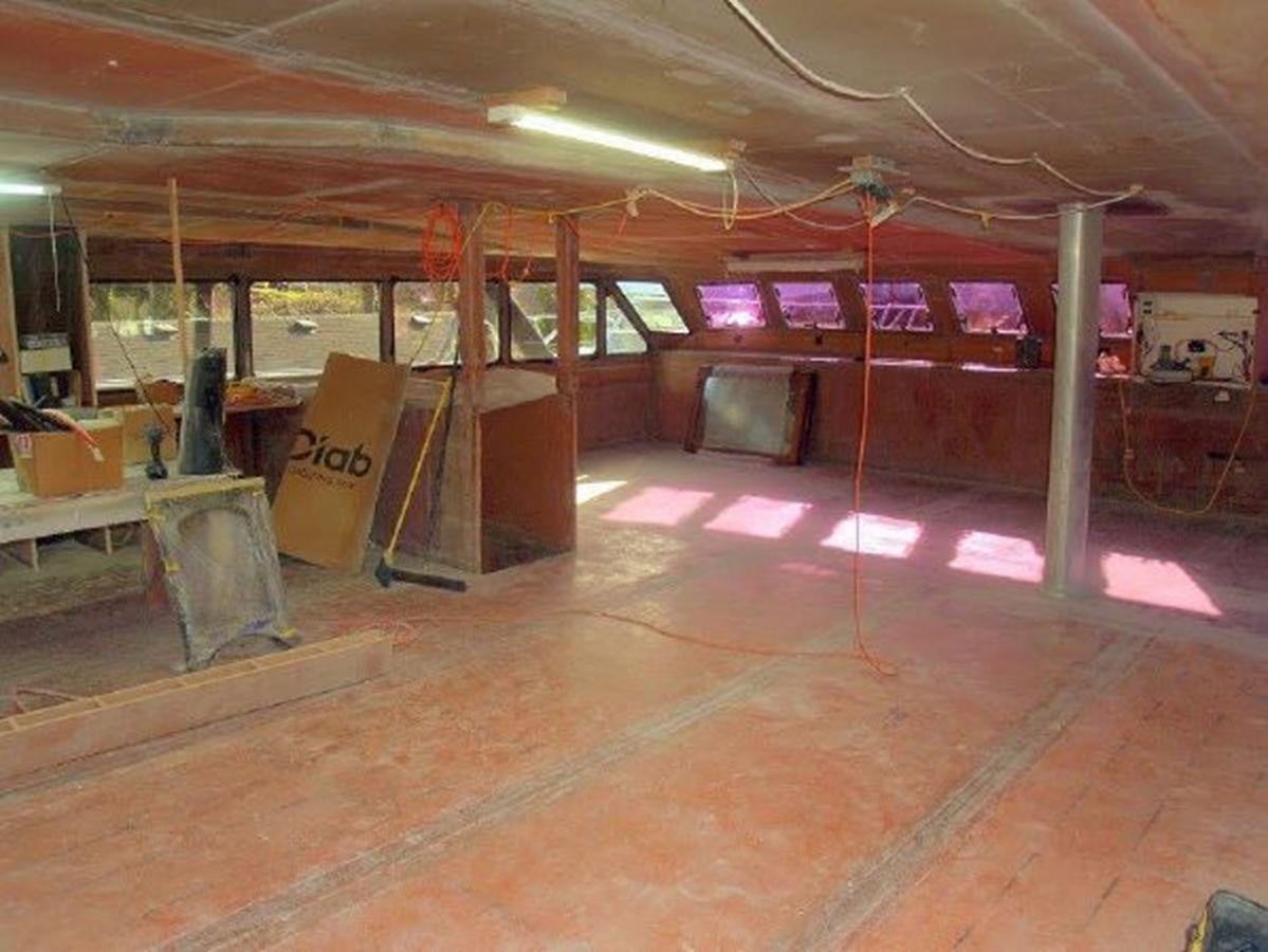 a large room with tables and chairs aboard 2023 PDIGREE CAT BLOOMFIELD Yacht for Sale