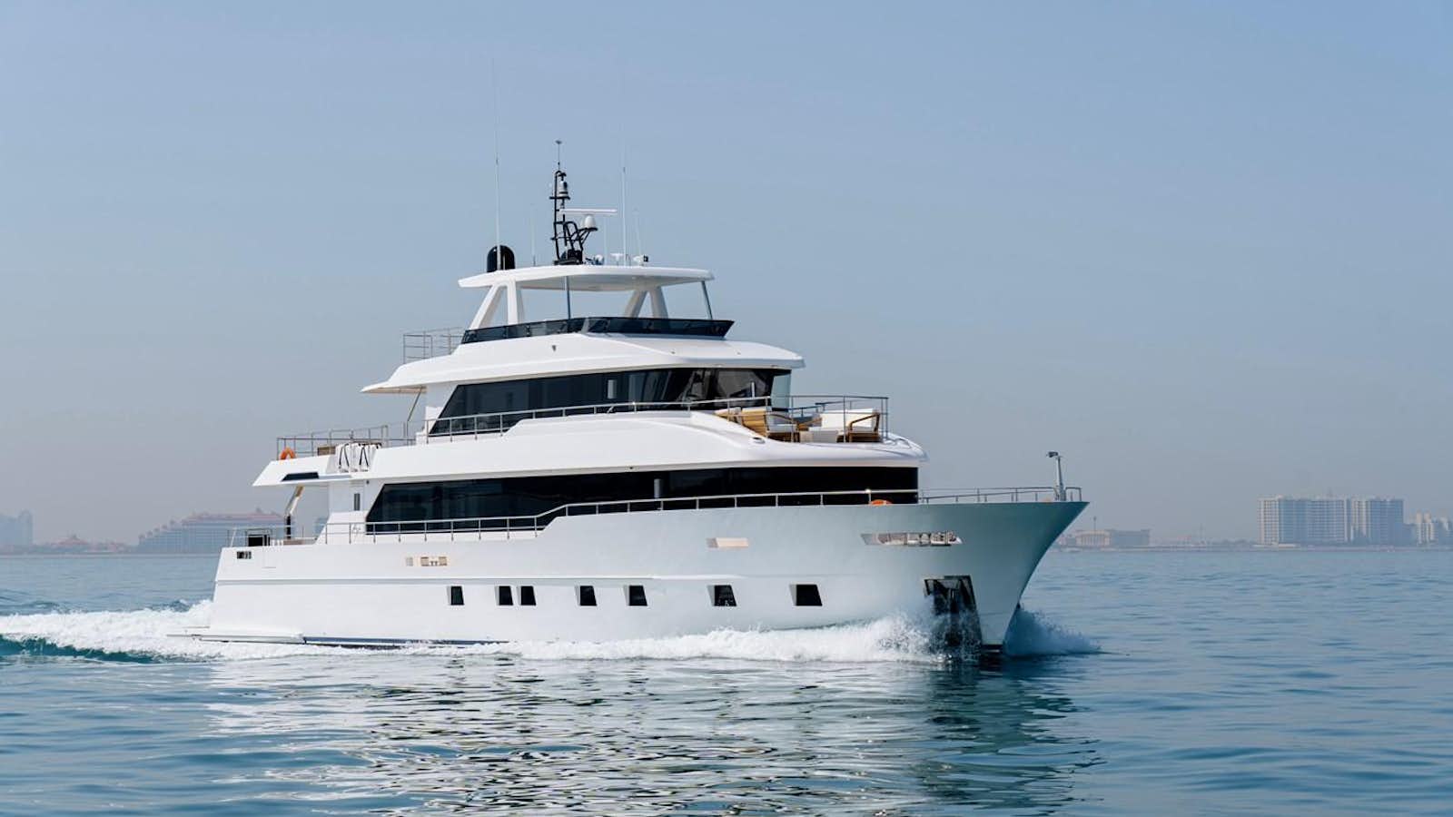 a white yacht in the water aboard NOMAD 101 Yacht for Sale