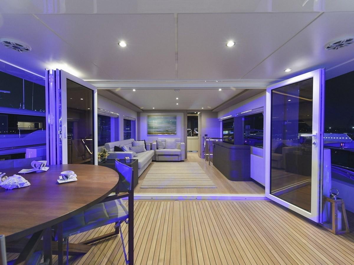 a room with a table and chairs aboard SG Yacht for Sale