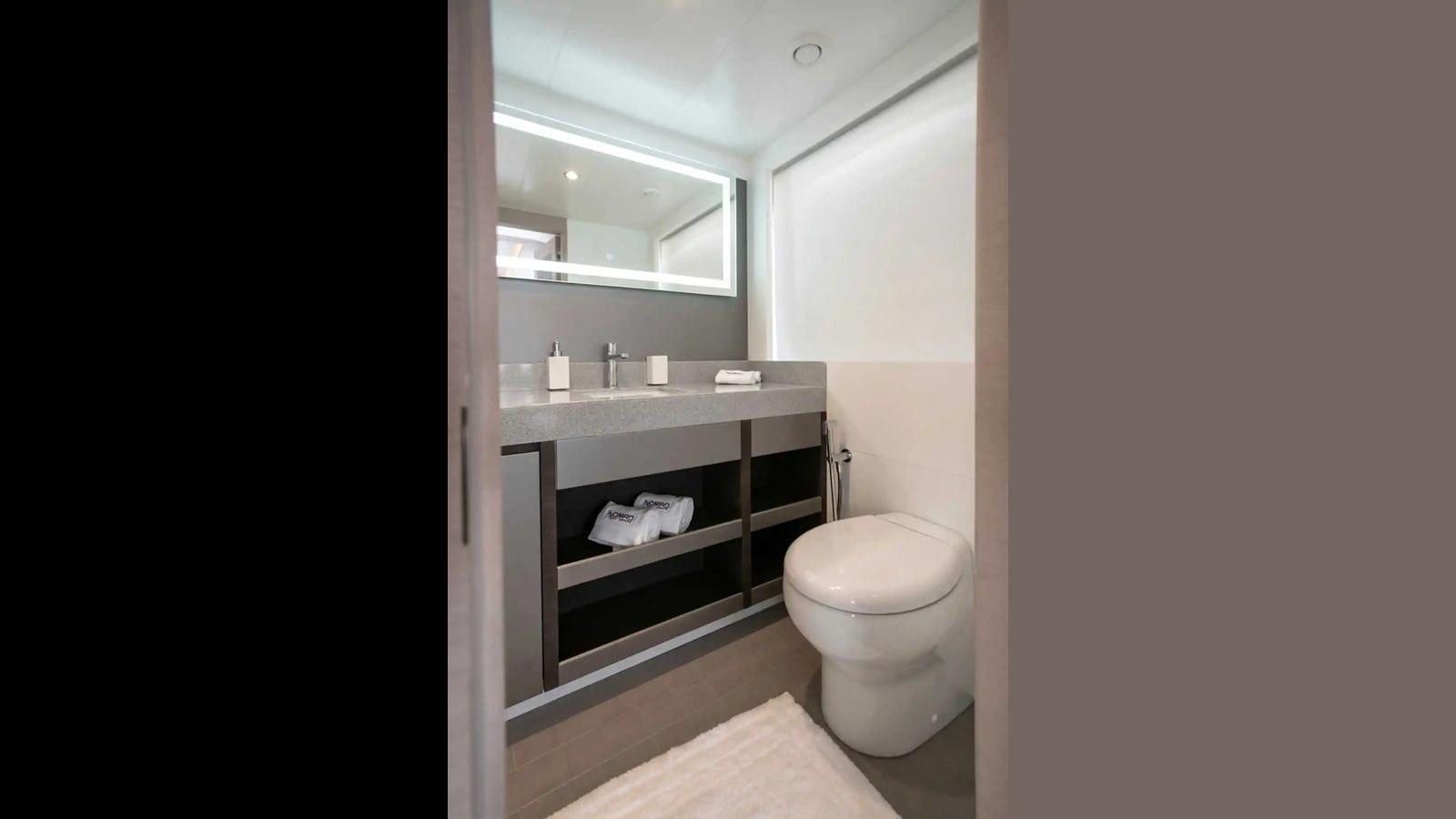 a bathroom with a toilet and a mirror aboard SG Yacht for Sale