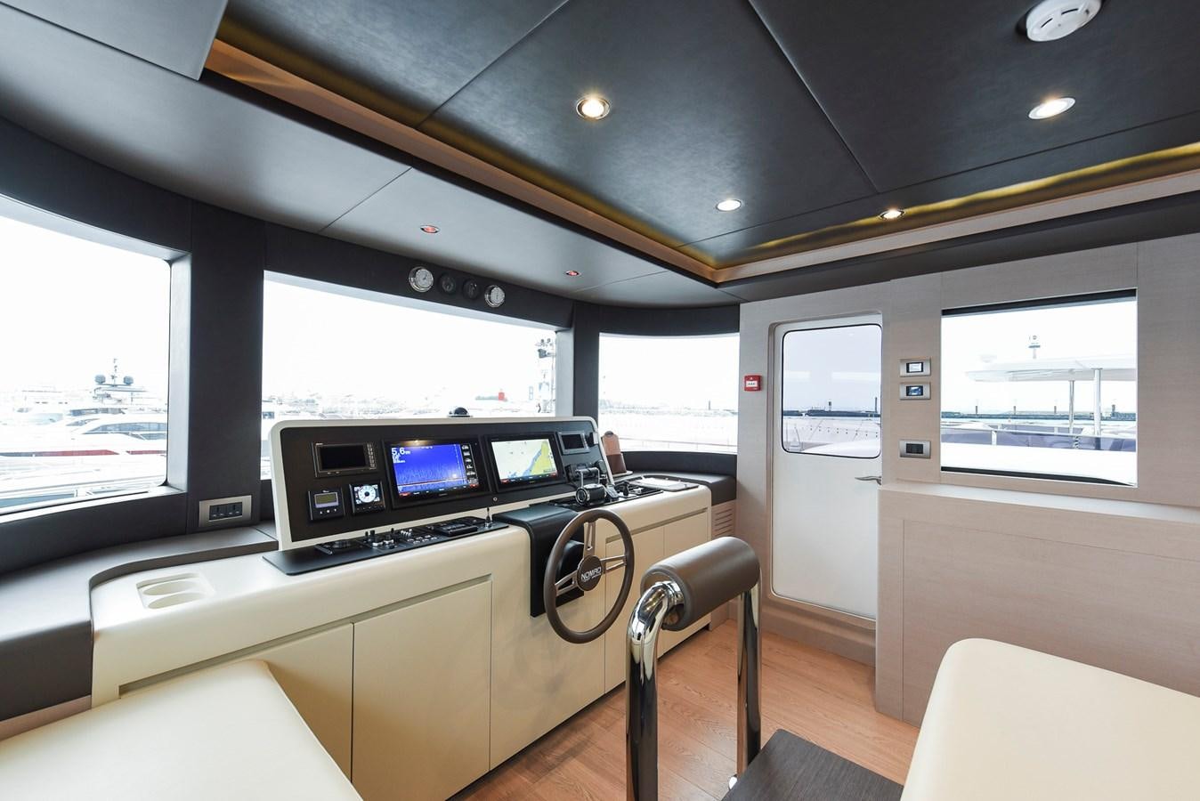 inside of a vehicle with a large screen and a desk with a chair and a window aboard SG Yacht for Sale